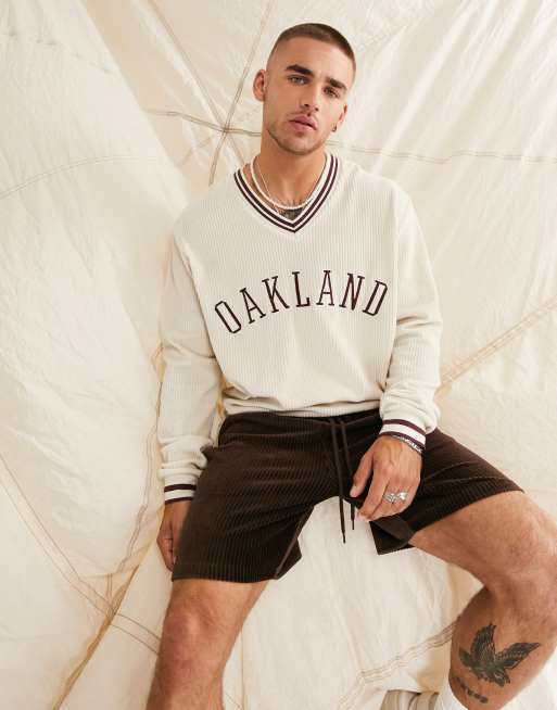 ASOS DESIGN - Felpa oversize in velour a coste con scollo a V e ricamo di città