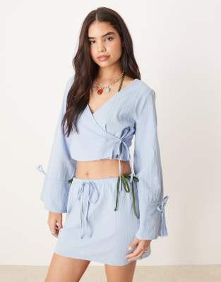 Asos Design Fern Frayed Wrap Front Beach Top In Ice Blue