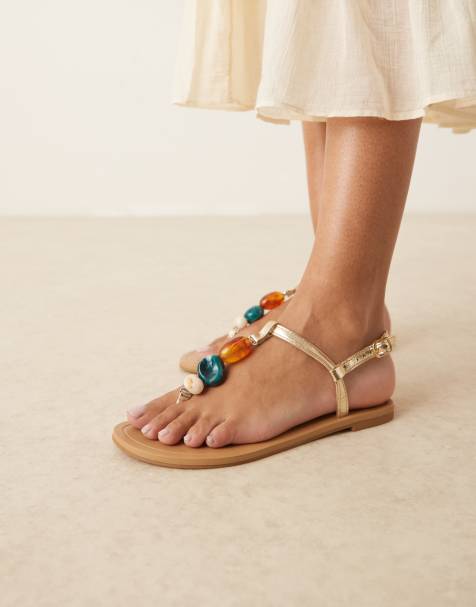ASOS DESIGN Feud toe post flat sandals with stones in gold - view 1