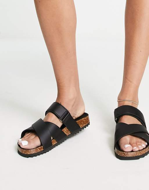 ASOS DESIGN Wide Fit Frenzy cross strap flat sandals with chain in black