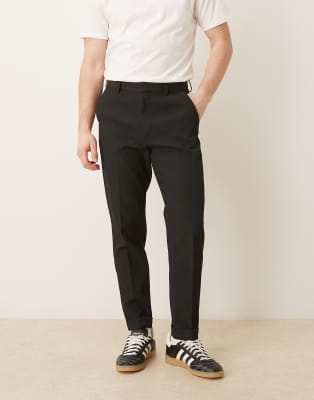 Figurbetonte, schmal zulaufende, bequeme Hose in Schwarz mit Rippenstruktur und Umschlag Schwarz 52 Regular