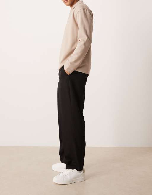 ASOS DESIGN – Figurbetonte, schmal zulaufende Hose in Schwarz mit lockerem Schnitt und elastischem Einsatz am Bund, 3 von 5