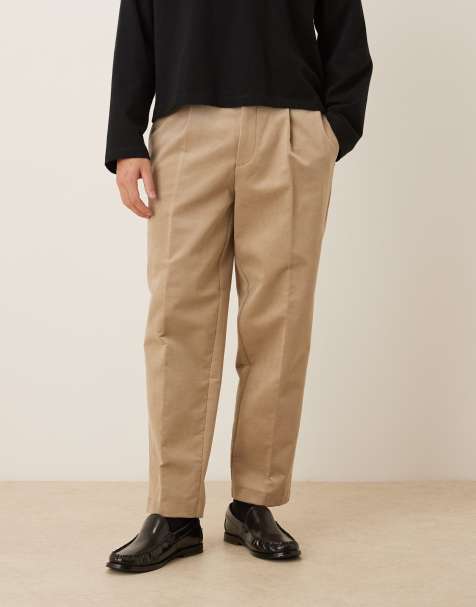 ASOS DESIGN – Figurbetonte, schmal zulaufende Oversize-Hose in dunklem Steinbeige mit Bundfalten - view 1