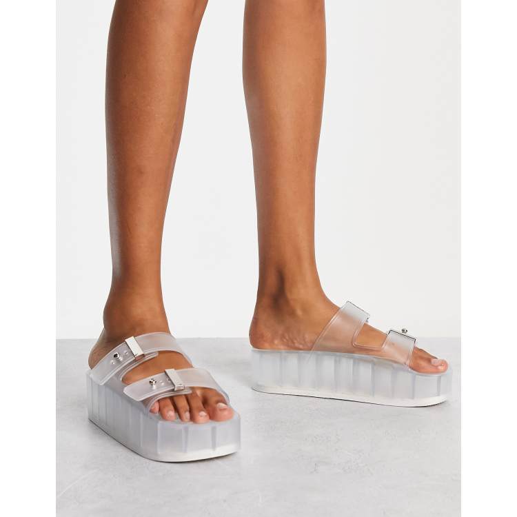 ASOS DESIGN Finale buckle platform flat sandals in clear ASOS