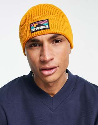 ASOS DESIGN ASOS DESIGN fisherman ribbed beanie with rubber logo in burnt orange