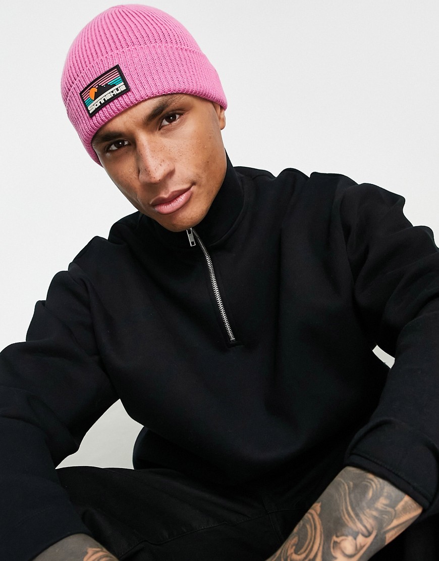 ASOS DESIGN fisherman ribbed beanie with rubber logo in pink