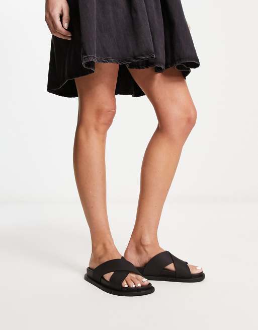 ASOS DESIGN Fixation cross strap jelly flat sandals in black | ASOS