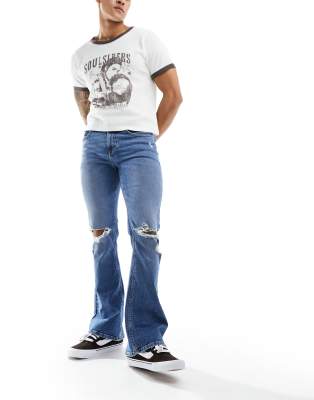 Asos Design Flare Jeans With Rips In Mid Wash Blue