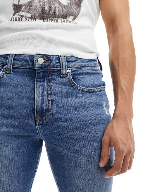 ASOS DESIGN flare jeans with rips in mid wash blue, 4 of 5