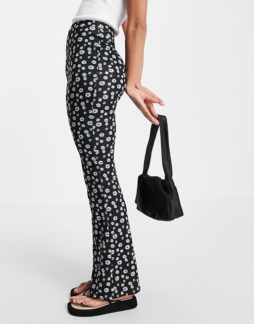 ASOS DESIGN flare trouser in black based daisy print