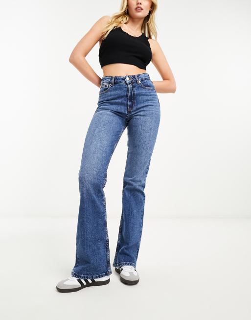 ASOS DESIGN low rise flare jean with belt in mid wash blue