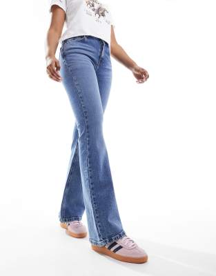 Asos Design Petite Flared Jeans In Mid Blue