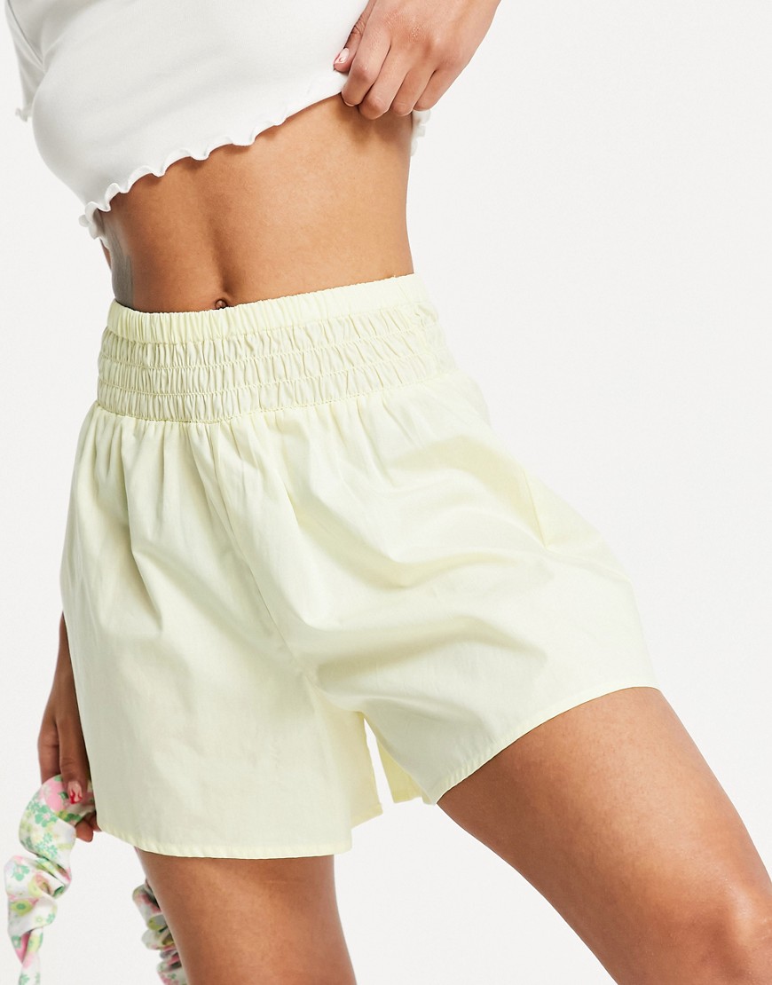 ASOS DESIGN flippy cotton shorts with shirred waist in washed yellow
