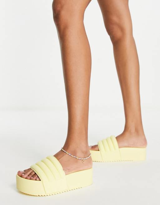 ASOS DESIGN Flori flatform slides in pale yellow ASOS