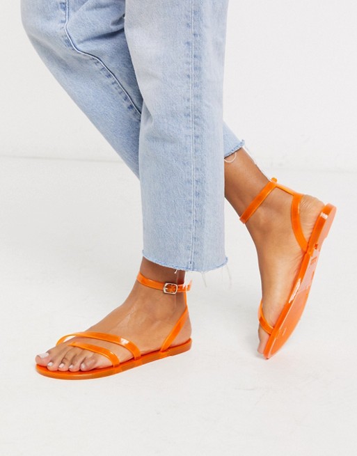 ASOS DESIGN Fluke asymetric jelly flat sandals in neon orange