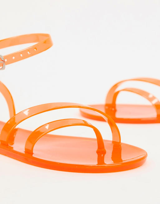 ASOS DESIGN Fluke asymetric jelly flat sandals in neon orange ASOS