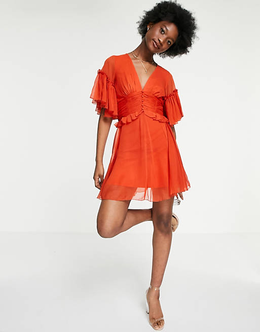 Women flutter sleeve mini dress with pleated waist and button detail in rust 