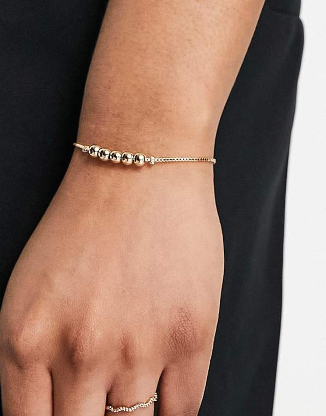 ASOS DESIGN friendship braclet with ball detail in gold tone