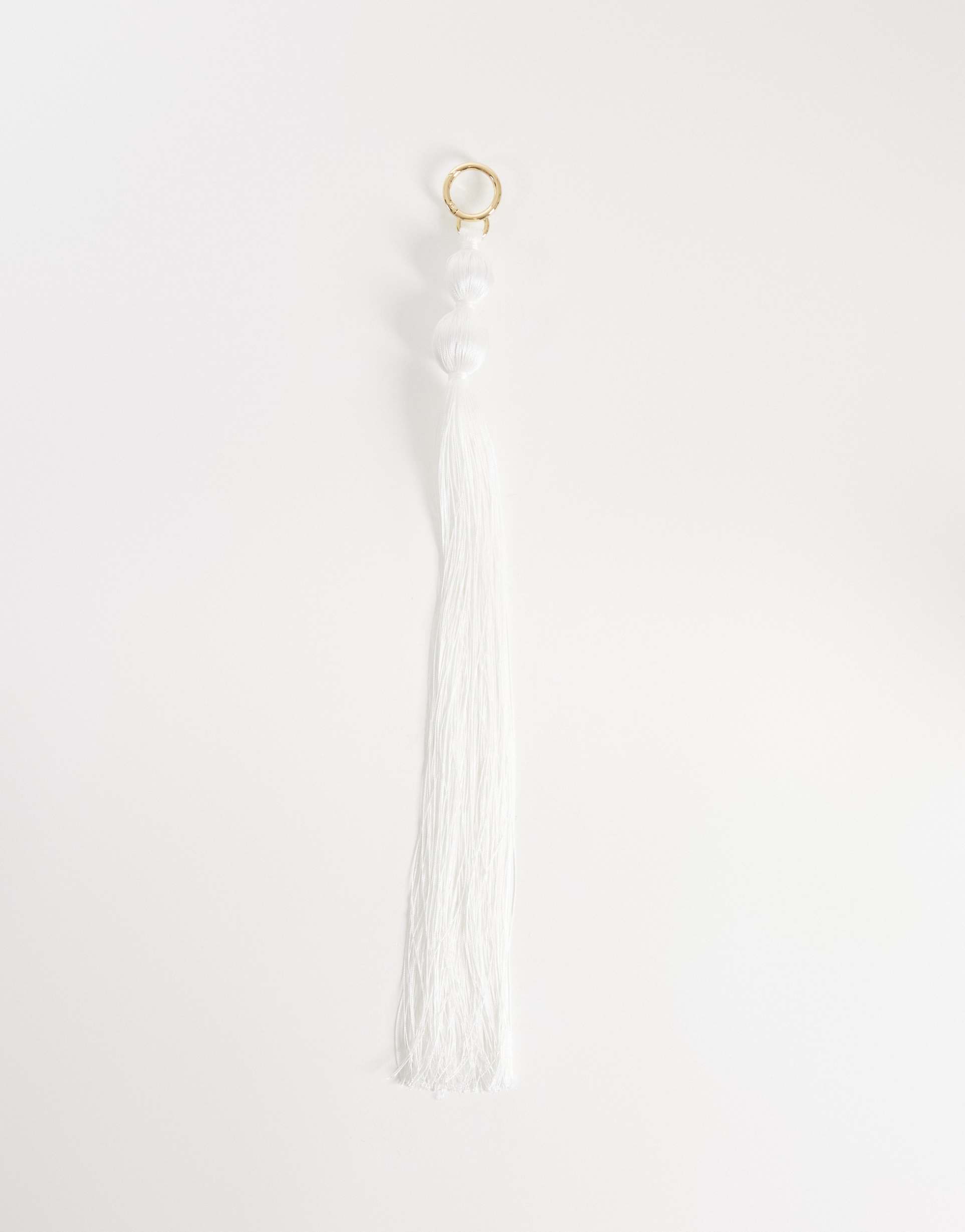 asos design fringe bag charm in cream