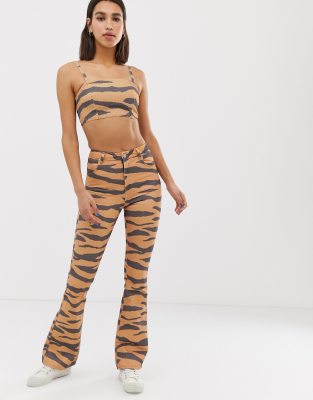 ASOS DESIGN Full length bell flare jeans in tiger print-Brown