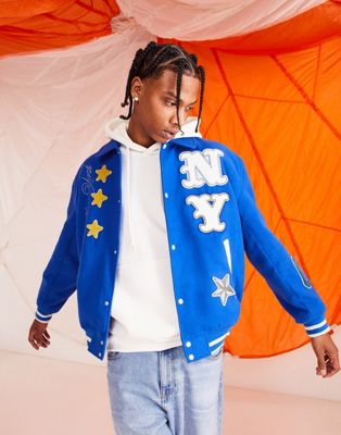 ASOS DESIGN oversized wool look varsity jacket with badges in blue - ASOS Price Checker