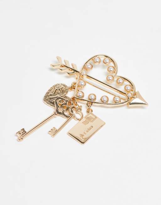 ASOS DESIGN gold brooch with attached charms