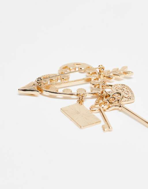 ASOS DESIGN gold brooch with attached charms