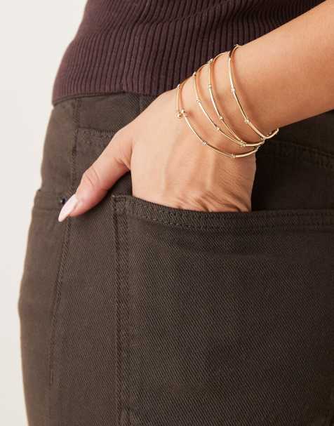 ASOS DESIGN – Goldfarbene, mehrreihige Stretch-Armbänder - view 1