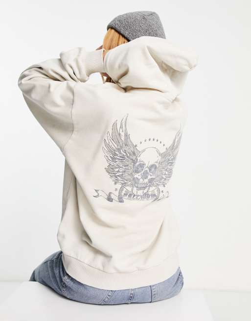 ASOS DESIGN graphic oversized hoodie with skull and feathers in stone