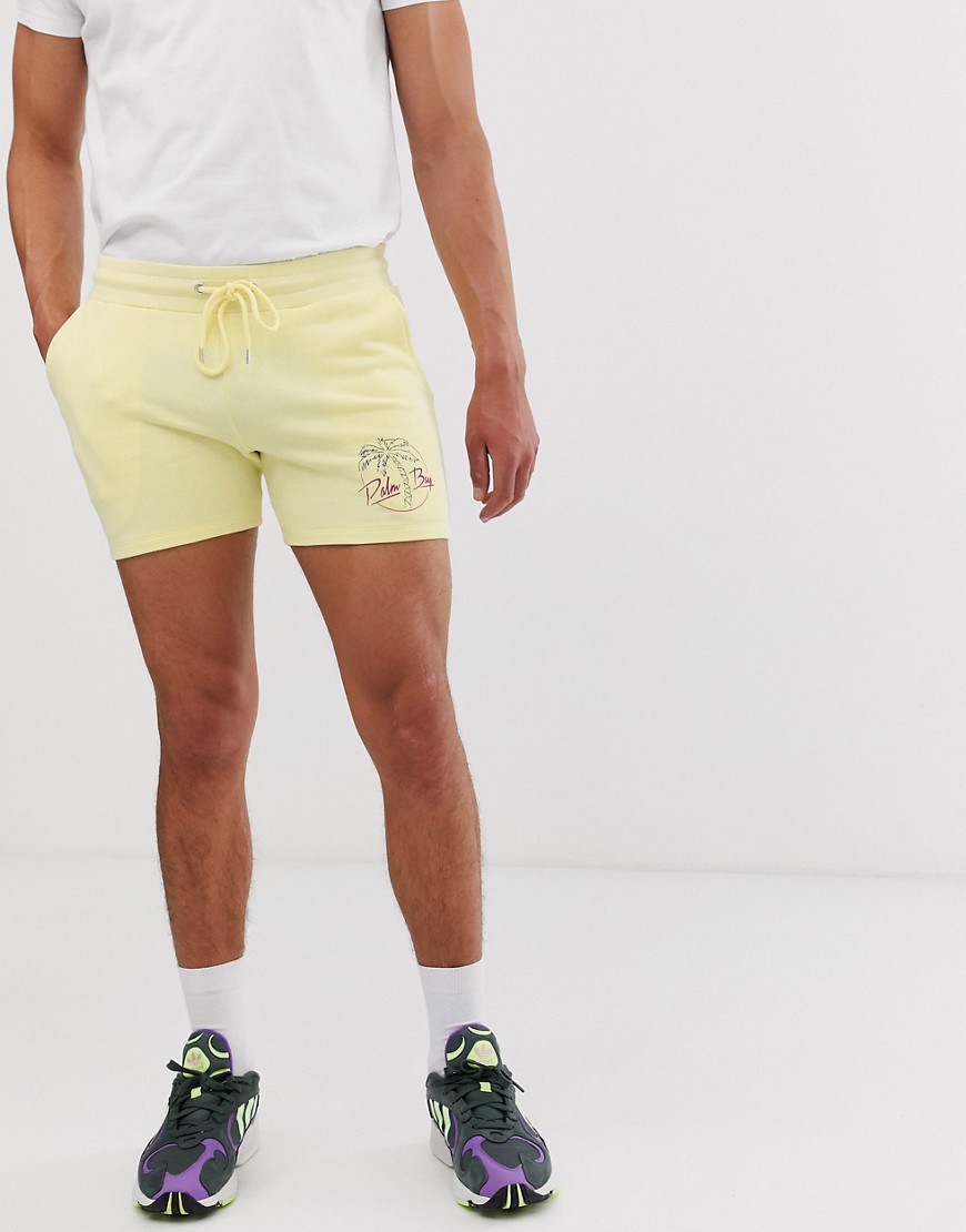ASOS DESIGN – Gula korta shorts med extra smal passform och palmmönster
