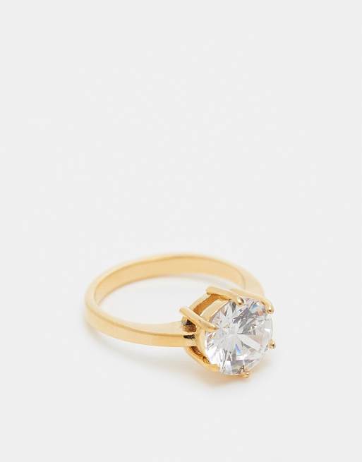 ASOS DESIGN – Guldfärgad ring i rostfritt stål med rund kubisk zirkonia och presentpåse
