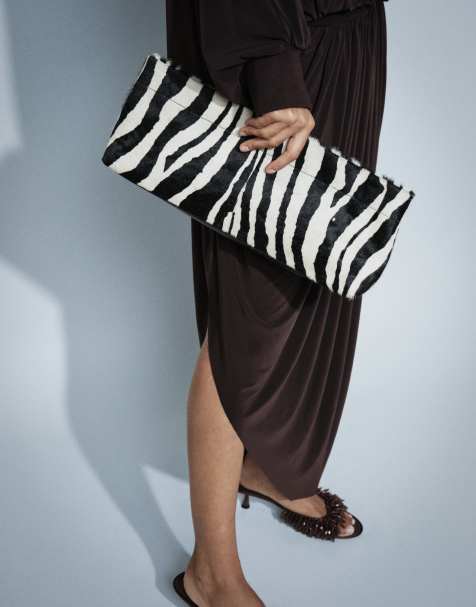 ASOS DESIGN hair on leather elongated pouch grab bag in zebra print - view 1
