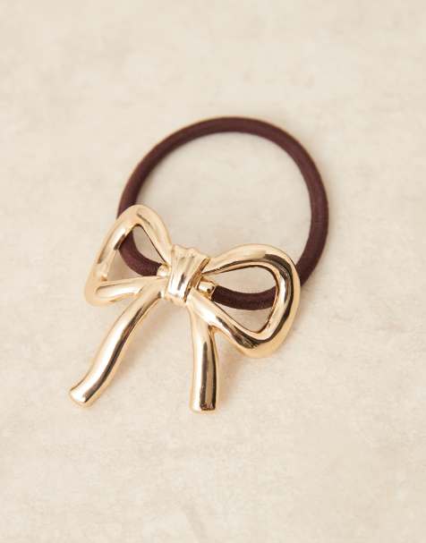 ASOS DESIGN hairband with metal bow detail in gold - view 1