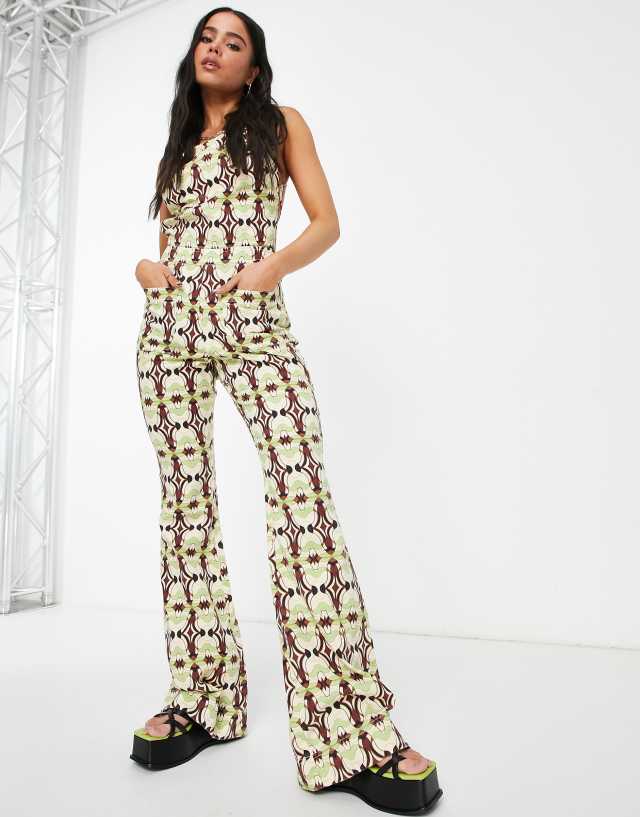 ASOS DESIGN halter neck jumpsuit with flare leg in geo print