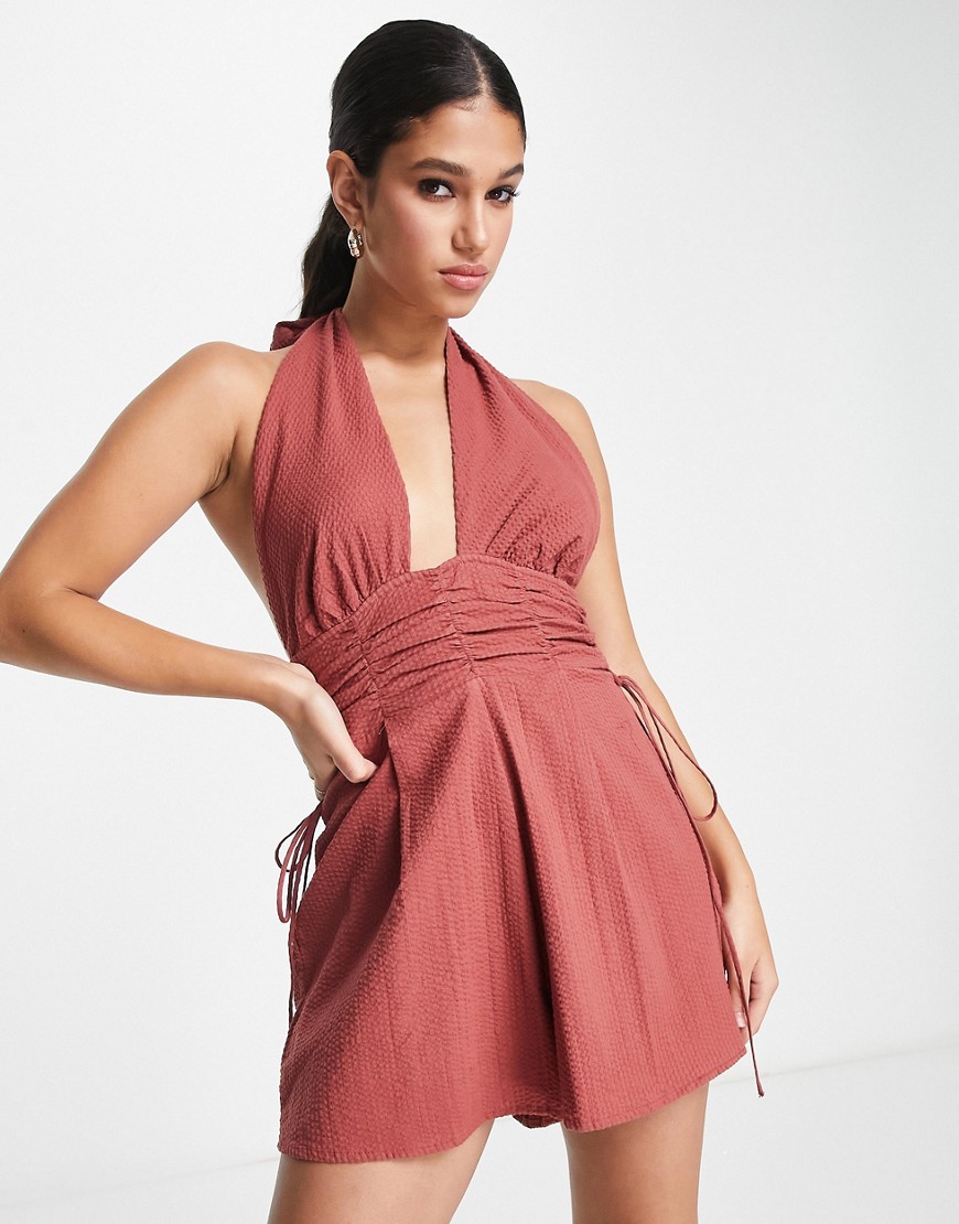 ASOS DESIGN halterneck playsuit with gathered waist and open back in brown