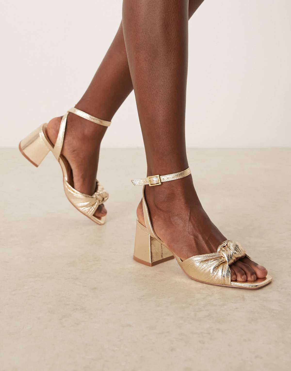 ASOS DESIGN Hansel knotted mid heeled sandals in gold