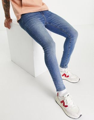 ASOS DESIGN – Hautenge Jeans mit Power-Stretch in mittlerer Vintage-Waschung-Blau