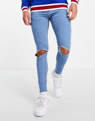 ASOS DESIGN – Hautenge Jeans mit Powerstretch in heller Stone-Waschung mit Knierissen-Blau
