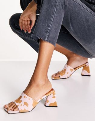 ASOS DESIGN Healing suede triangle heeled mules in cow print