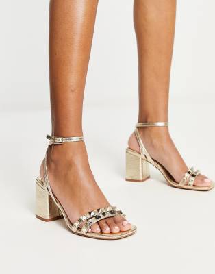 ASOS DESIGN Heath studded mid heeled sandals in gold