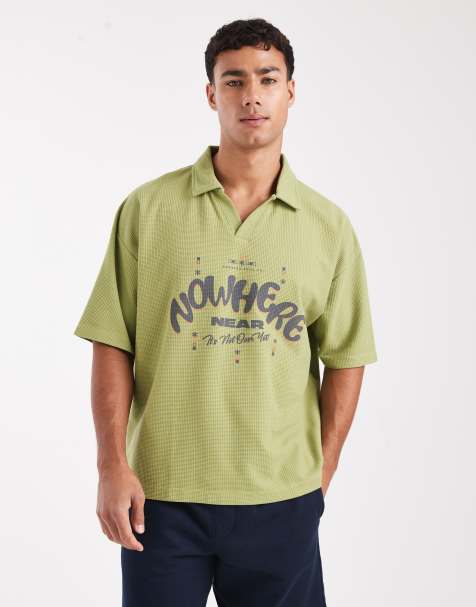 ASOS DESIGN heavyweight boxy oversized polo shirt with text graphic in green texture - view 1