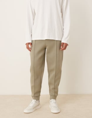ASOS DESIGN heavyweight tapered sweatpants in scuba-style fabric with pin tucks in khaki-Green