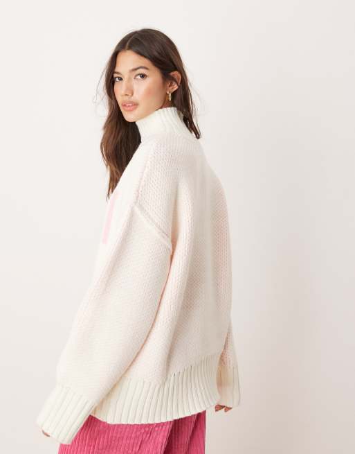 ASOS DESIGN high neck chunky jumper with ski slogan in cream