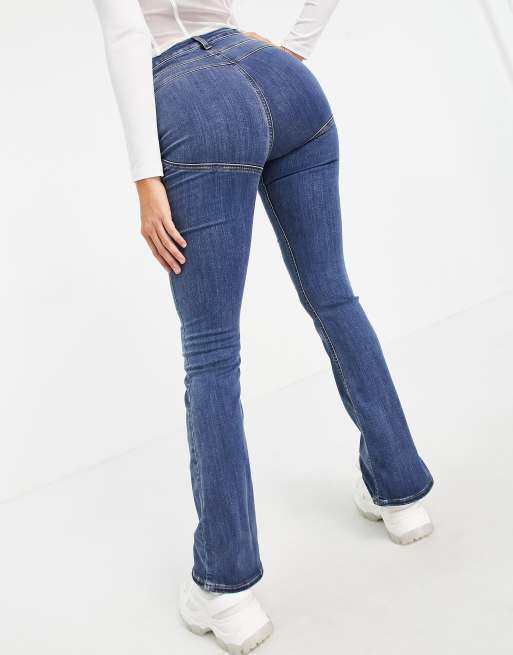 ASOS DESIGN Tall high rise 'lift and contour' stretch flare jeans in mid  blue