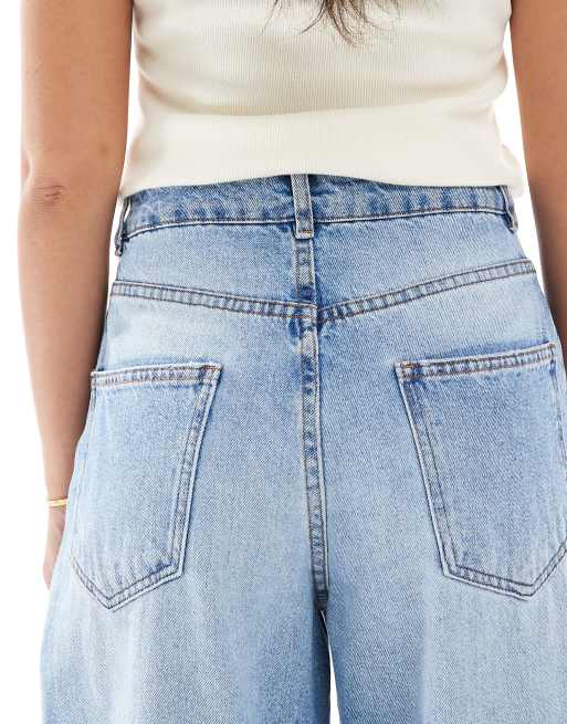 ASOS DESIGN high rise barrel jeans in mid blue with rips