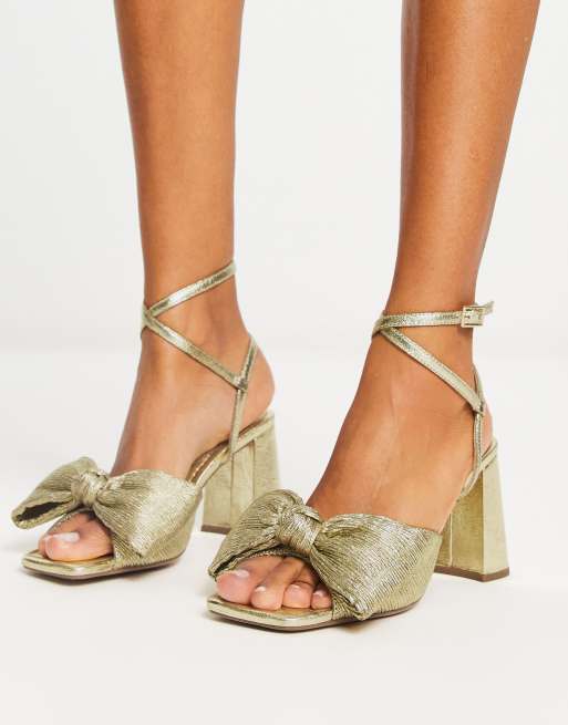 ASOS DESIGN Hitched bow detail mid block heeled sandals in gold ASOS