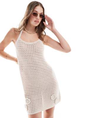 ASOS DESIGN holiday knitted halter mini dress with 3D flowers in cream-Neutral