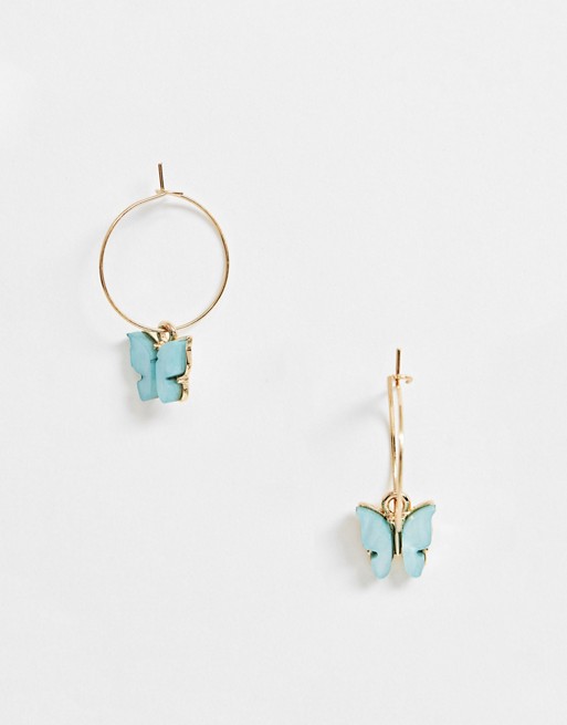 ASOS DESIGN hoop earrings with blue butterfly charm in gold tone