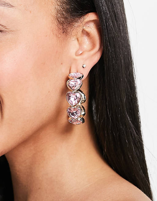 ASOS DESIGN hoop earrings with pink crystal hearts in gold tone
