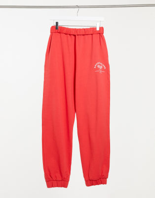 ASOS DESIGN roll waist oversized sweatpants with tennis logo in red